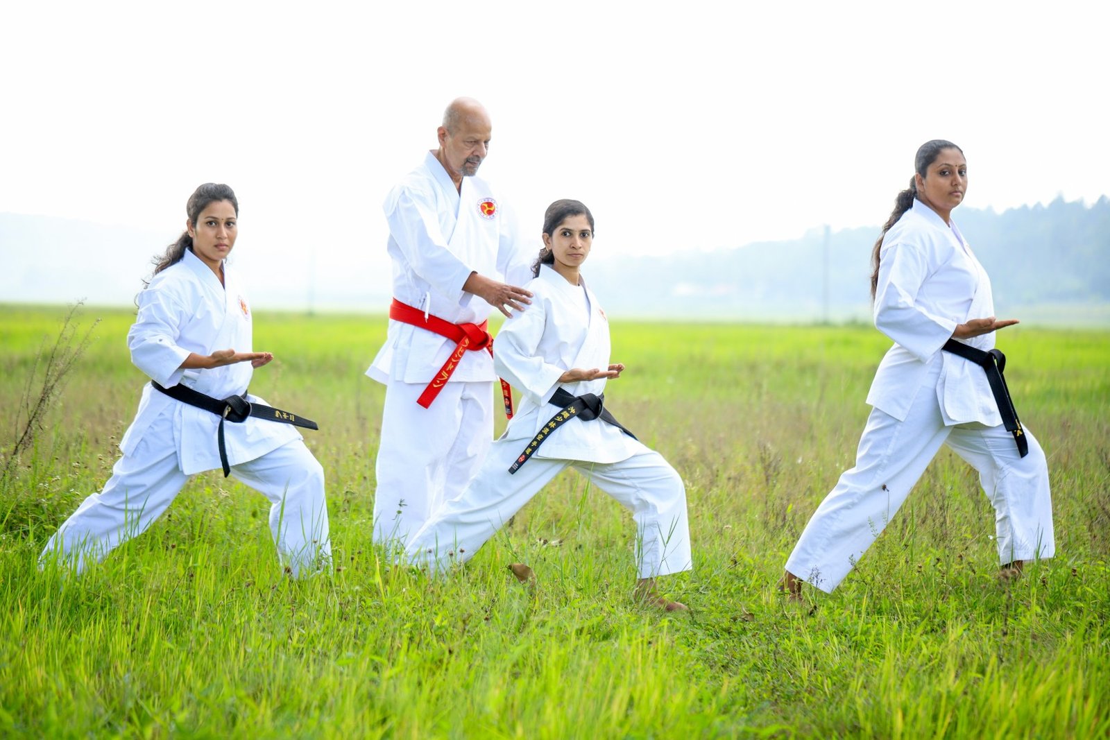 hanshi ravindran k.p providing one on one technique corrections to a student during a karate lesson.n (large)